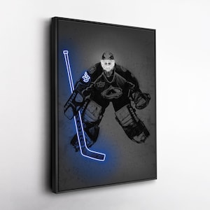 May include: A black and white illustration of a hockey goalie in full gear, with a glowing blue hockey stick. The goalie is wearing a helmet and pads, with the number 35 visible. The artwork is set against a dark grey background.