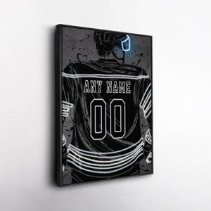 May include: Framed artwork featuring a hockey player from the back, wearing a jersey with the text "ANY NAME" and the number "00". The artwork is in black and white with neon blue accents, set against a gray background with paint splatters.
