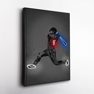 May include: A framed art print featuring a baseball player in action, rendered in a neon-style illustration. The player is wearing a jersey with the number 5, and the bat glows blue. The artwork is set against a dark gray background.