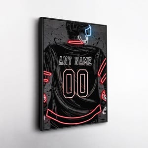 May include: Black framed wall art featuring a hockey player's jersey with the text "ANY NAME" and the number "00" in white. The jersey has red and neon blue accents, with a gray background.