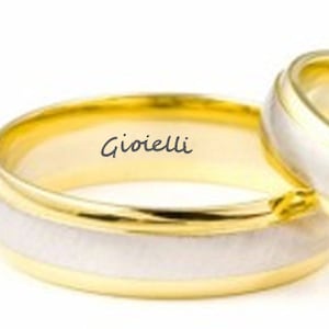 May include: Two gold wedding bands, one with a white gold inlay and the inscription "Gioielli" on the inside.