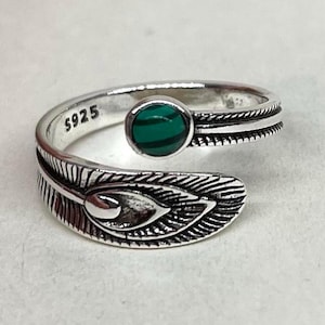 May include: An adjustable silver ring with a feather design. It features a round, green stone and is stamped with "S925". The feather detail wraps around the finger. A unique and stylish piece of jewellery.
