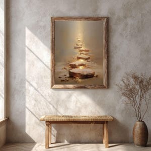 Op de afbeelding: Een ingelijste kunstdruk toont een pad van stapstenen badend in gouden licht. Het kunstwerk zit in een houten lijst en hangt boven een houten bank. Rechts staat een vaas met gedroogde takken.