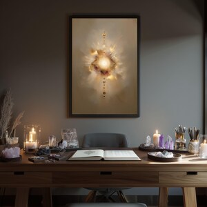 May include: A framed abstract art print with a central burst of light and color, in shades of gold, cream, and burgundy. The print hangs above a wooden desk adorned with candles, crystals, and an open book, creating a mystical ambiance.