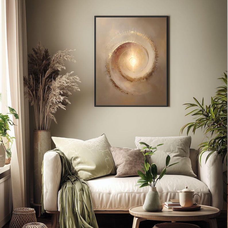 May include: A framed abstract art print featuring a spiral design with warm, earthy tones of beige, brown, and gold. The artwork hangs above a white sofa with green and brown throw pillows. The room is decorated with plants and a wooden coffee table.