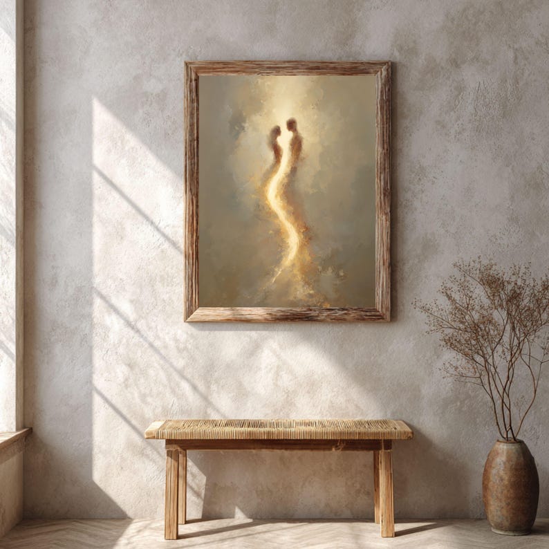 May include: A framed wall art piece featuring an abstract painting of two figures standing close together, illuminated by a bright, vertical golden light against a muted, textured beige and brown background with soft, blended brushstrokes.