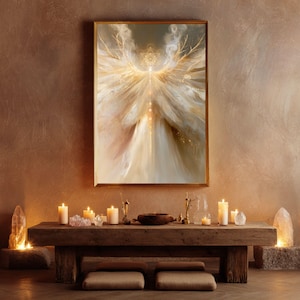 May include: A rectangular wall art print in a gold frame featuring an ethereal, glowing figure with expansive, wing-like structures in shades of cream, white, and gold, displayed above a rustic wooden table with lit candles and crystals.