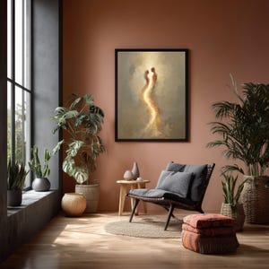 May include: A framed wall art print featuring an abstract, glowing silhouette of two figures facing each other, rendered in warm golden and beige tones. The artwork is displayed on a solid terracotta-colored wall above a wooden side table and chair.