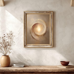 May include: A framed artwork featuring a spiral design with a bright, central light source. The artwork is in warm tones of beige, gold, and brown, and is displayed in a rustic wooden frame. The image is set against a neutral wall.