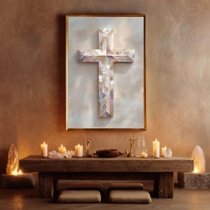 May include: A framed wall art piece featuring a three-dimensional cross constructed from iridescent, multi-faceted mother-of-pearl tiles. The cross is centered on a light, cloudy background within a thin gold frame, creating a reflective surface.