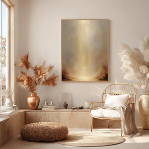 May include: A serene interior scene featuring a large abstract painting with a golden, ethereal glow. The room is decorated with natural elements, including pampas grass in copper vases, a woven chair, and a round woven ottoman, creating a warm and inviting atmosphere.