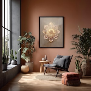 May include: A framed artwork with a geometric flower design in gold and beige tones adorns a terracotta wall. The room is furnished with a dark chair, plants, and a small wooden table, creating a calm and inviting atmosphere.