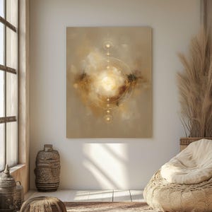 May include: Abstract canvas art featuring a central golden light surrounded by concentric circles and celestial accents. The artwork is primarily in shades of beige, brown, and gold, creating a warm and inviting atmosphere. The piece is displayed in a well-lit, neutral-toned room.