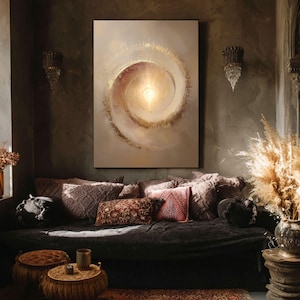 May include: A large abstract painting with a spiral design in shades of beige, gold, and brown hangs above a dark sofa with decorative pillows. The room has a bohemian aesthetic with sconces and decorative elements.