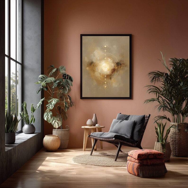 May include: An abstract art print in a black frame hangs on a terracotta-colored wall. The artwork features a central golden light surrounded by circular and linear designs. A dark wicker chair with gray cushions sits near a small wooden table.