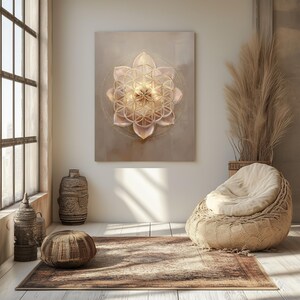 May include: A canvas artwork with a glowing, geometric flower design in pink and gold hues. The artwork hangs on a neutral wall in a room with natural light, a woven chair, and decorative vases. The room has a rug and pampas grass.