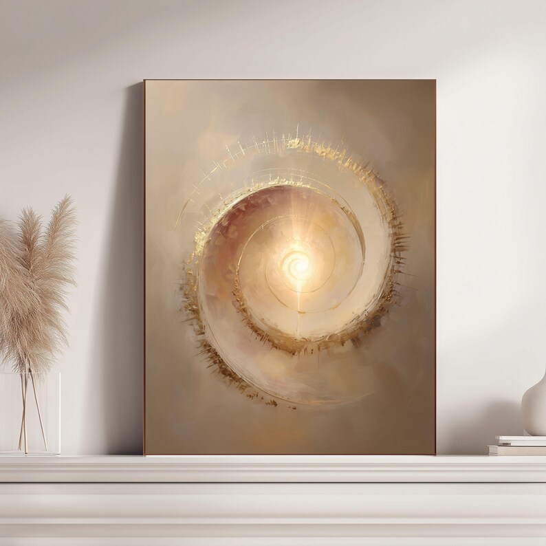 May include: Abstract art print featuring a spiral design with a bright, central light source. The artwork uses warm tones of gold, beige, and brown, creating a sense of depth and movement. The framed piece is displayed on a white surface.