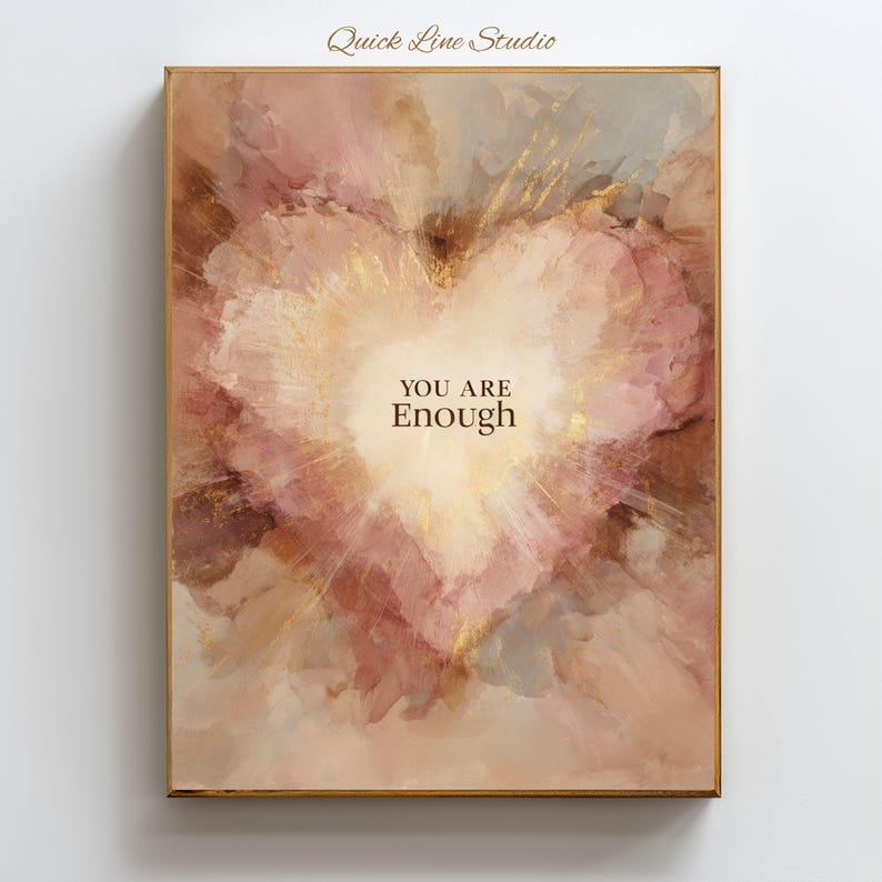 May include: A framed art print with a heart-shaped design. The artwork features a soft, watercolor-style background in shades of pink, brown, and gold. The words "YOU ARE Enough" are centered within the heart.