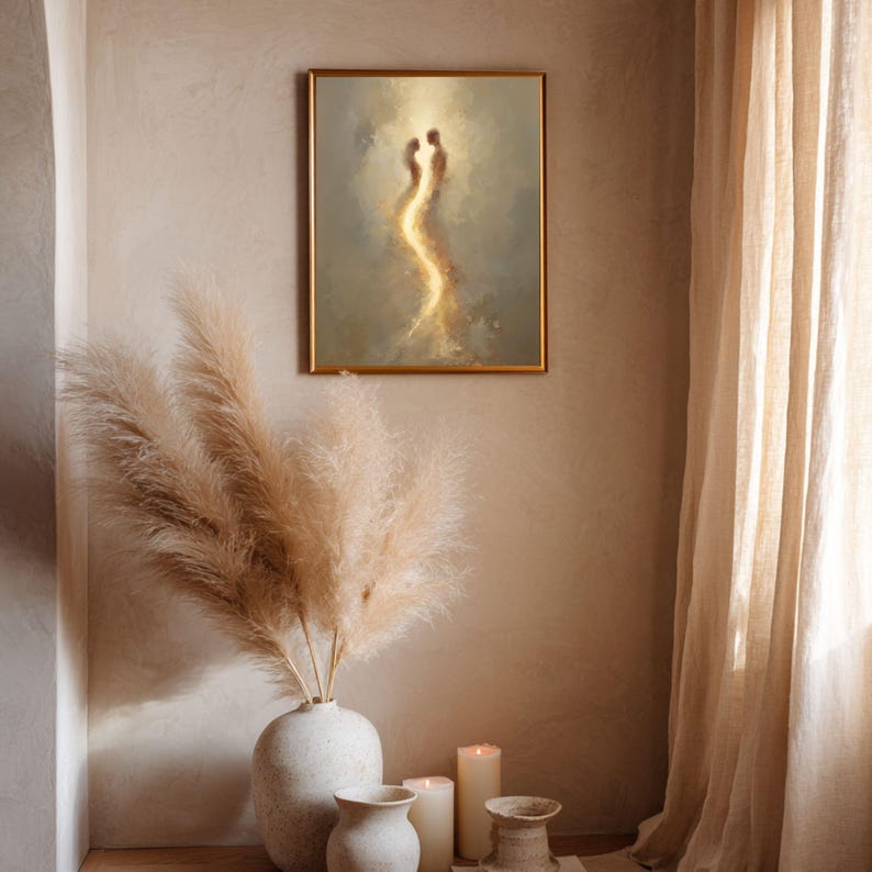 May include: A rectangular framed wall art piece featuring an abstract painting of two glowing, ethereal figures in shades of gold, beige, and soft brown. The artwork is displayed in a thin gold frame, showcasing a vertical composition of light.