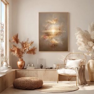 May include: A framed abstract art print with a celestial design in warm tones of gold, beige, and brown. The artwork hangs above a wicker chair with a white cushion and a woven ottoman. Dried pampas grass in vases adds a natural touch to the room.