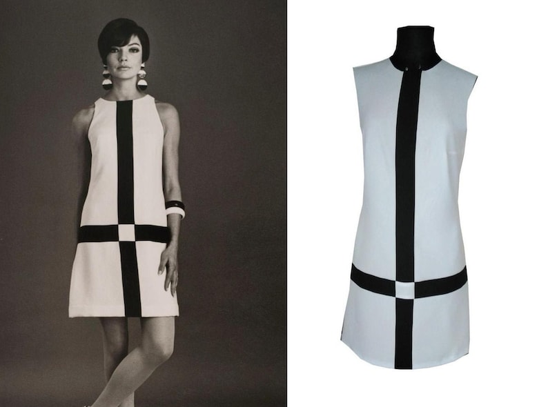 May include: A sleeveless white dress with a black geometric pattern. The dress has a high neckline and a straight silhouette.