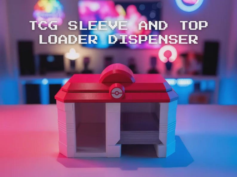 May include: A red and white TCG sleeve and top loader dispenser. The dispenser has a red roof and a white body with a circular design on the front. The text "TCG SLEEVE AND TOP LOADER DISPENSER" is displayed above the dispenser.