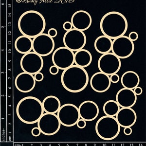 May include: A set of 16 die-cut circles in various sizes, arranged in a pattern on a black background. The circles are made of a beige material and are perfect for crafting projects.