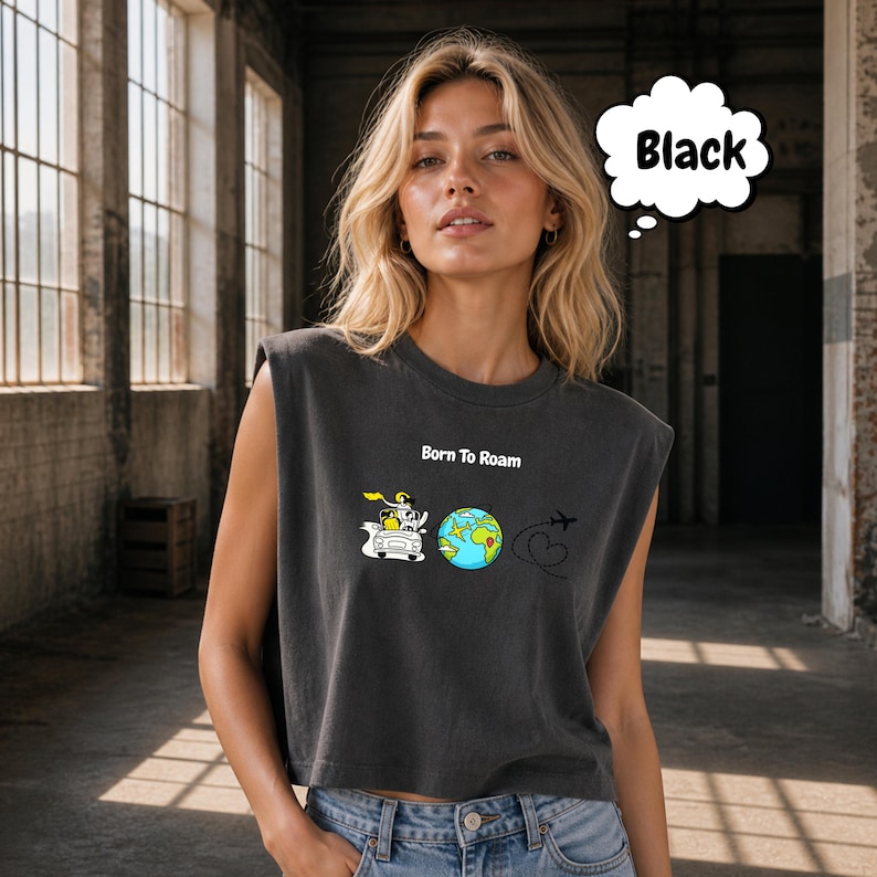 May include: Black sleeveless crop top with the text "Born To Roam" and a graphic of a car, globe, and airplane. The globe is blue and green. The top is worn by a person.