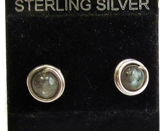 May include: Sterling silver earrings with a dark gray gemstone set in a silver wire wrap.