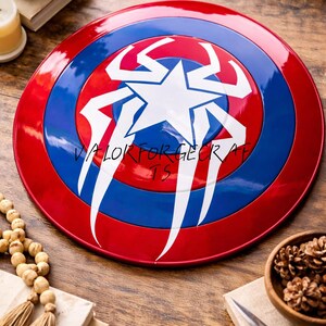 May include: A red, white, and blue shield with a star and stylized design. The shield has a circular shape with the text "VALORFORGE CRAFTS" on it. The shield is a prop or collectible.