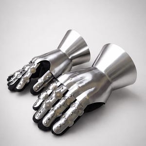 May include: A pair of articulated metal gauntlets featuring a polished silver finish. Each gauntlet consists of a flared cuff, a protective plate for the back of the hand, and segmented finger coverings secured with small rivets over a black lining.