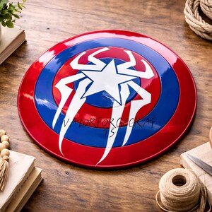 May include: A red, white, and blue shield with a star and lightning bolt design. The shield is round and has a glossy finish. The text "VALORFORGEECKS" is printed on the shield. The shield is a collectible item.