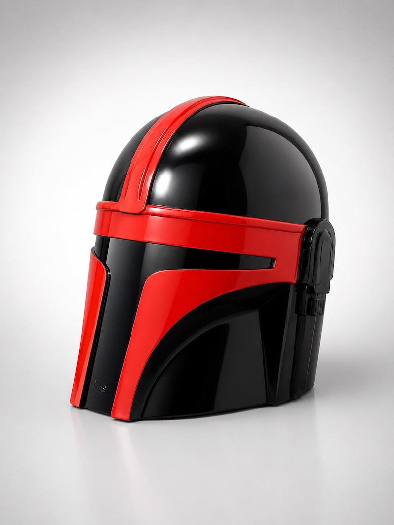 May include: A glossy black and red helmet featuring a smooth, rounded dome, a central vertical red stripe, and a horizontal red band across the visor area. The design includes a T-shaped faceplate with red accents and a side ear piece detail.