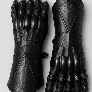May include: A pair of matte black articulated gauntlets featuring intricate embossed scrollwork patterns on the forearm plates and segmented finger armor with pointed tips. The metal construction includes overlapping plates and rivets.