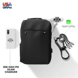 May include: A black backpack, a white charger, and a black charging cable are displayed on a white background. The charger has the text "YOUR BRAND HERE" and "20K MAH PD 22.5W CHARGER". The charging cable has the text "YOUR BRAND HERE" and the Apple CarPlay logo.