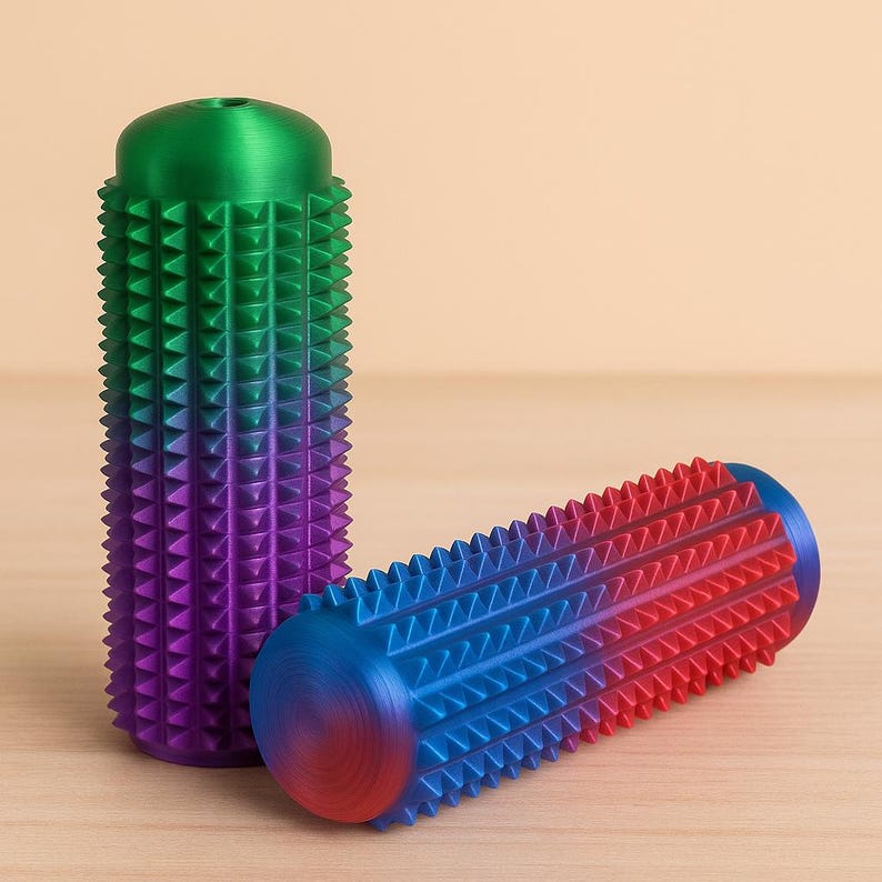 May include: Two colorful, textured massage rollers. One is upright, with a green to purple gradient. The other is horizontal, with a blue to red gradient. Both have a series of triangular spikes.