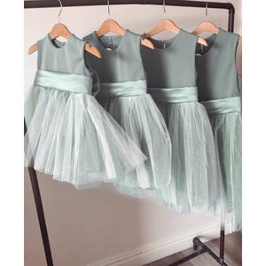 Sage green tutu flower girl dress with sparkly tulle & a large green bow sash handmade in the UK
