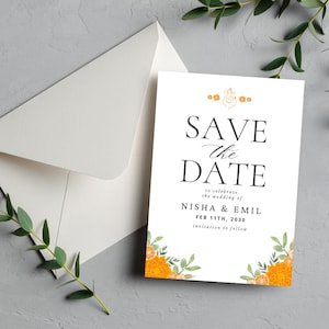 May include: A white 'Save the Date' card with black text and orange floral accents. The card includes the names 'Nisha & Emil' and the date 'FEB 11TH, 2030'. An envelope is visible in the background.