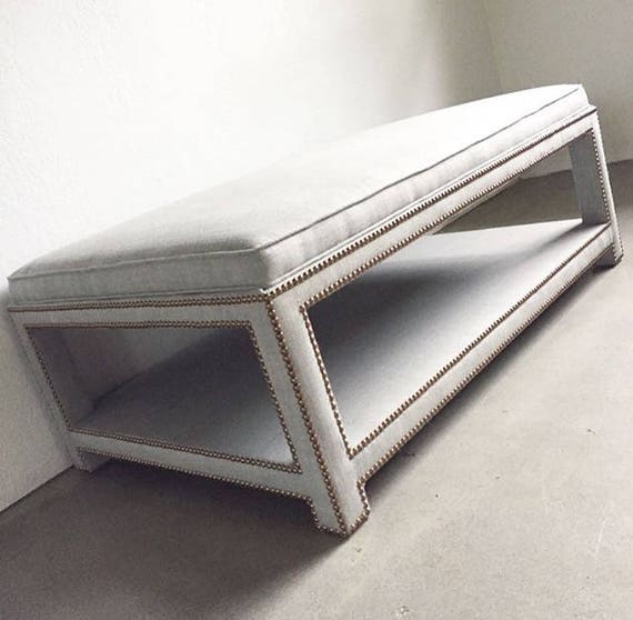 Upholstered ottoman with online shelf