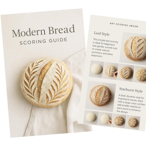 May include: An image of a "Modern Bread Scoring Guide" and an "Art Scoring eBook" showing bread scoring techniques. The guide features a loaf with a leaf design. The bread has a golden crust and intricate patterns.