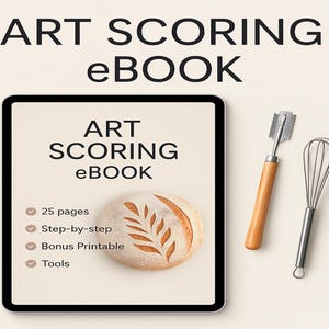 May include: An ebook titled "ART SCORING" displayed on a tablet, with a loaf of bread featuring a leaf design. Includes a bread lame and a whisk. The ebook promises 25 pages, step-by-step instructions, a bonus printable, and tools.