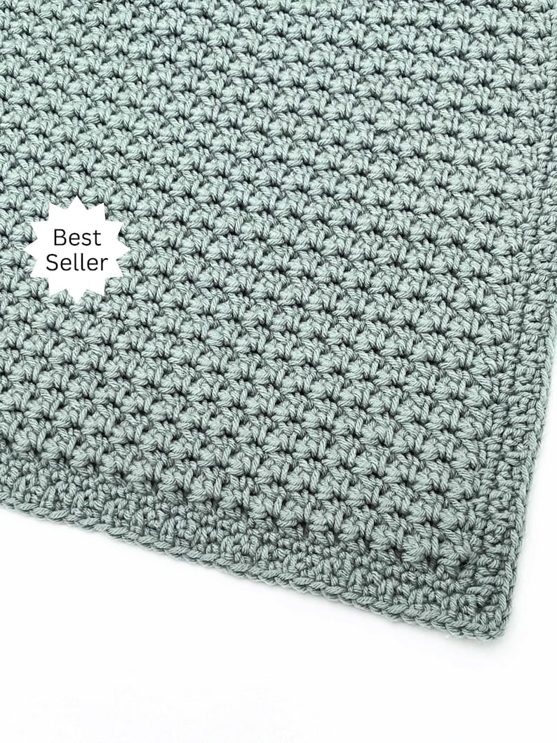 May include: A close-up of a crocheted blanket in a soft, muted green color. The blanket has a textured, woven appearance. A white starburst graphic with the words "Best Seller" is in the corner.
