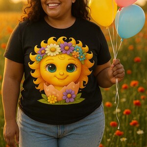 Cute cartoon sun character with big teal eyes and golden wavy rays, wearing a colorful daisy and flower crown, smiling from inside a cracked pastel pink egg covered in little hearts, with bright flowers and green grass at the base and a soft blue glowing sky behind. Playful spring and Easter graphic art, perfect for a cheerful kids T shirt design.