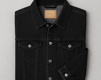May include: A black denim jacket with a classic design. The jacket features a button-up front, two chest pockets, and two side pockets. The label inside the collar reads "DENIM CO." and "EST. 1972". The jacket is folded neatly.