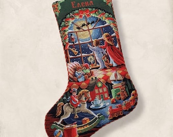May include: A Christmas stocking with a detailed cross-stitch design. The stocking features a winter scene with children, toys, and a snowy night sky. The name "Elena" is embroidered at the top. The color palette includes red, green, blue, and brown.