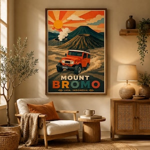 May include: A framed wall poster depicting a bright orange off-road vehicle driving across a sandy landscape toward Mount Bromo. The artwork features a stylized sun, clouds, and volcanic peaks with the text MOUNT BROMO JAVA, INDONESIA below.