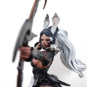 May include: A detailed figurine of a female archer with long white hair and rabbit-like ears. She wears a black outfit and holds a bow and arrow, ready to fire. The figure has a dynamic pose and intricate detailing.