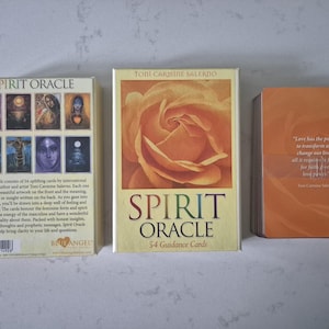 May include: Three decks of oracle cards. The deck on the left has the words "SPIRIT ORACLE" and images of people. The center deck has a rose image and the words "SPIRIT ORACLE 54 Guidance Cards". The deck on the right has text.