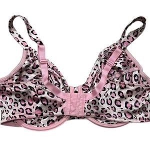 May include: A pink and white leopard print bra with adjustable straps and a hook-and-eye closure. The bra features a classic design with a satin-like finish, offering a touch of elegance and comfort.