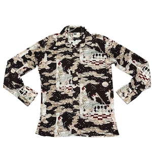 May include: A long-sleeved shirt with a brown background and a white, red, and black patterned design. The pattern features figures and clouds.